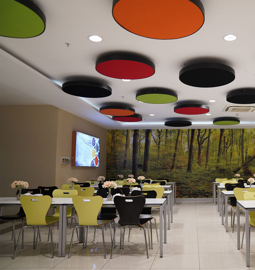 Colorful circular acoustic ceiling clouds above a dining area