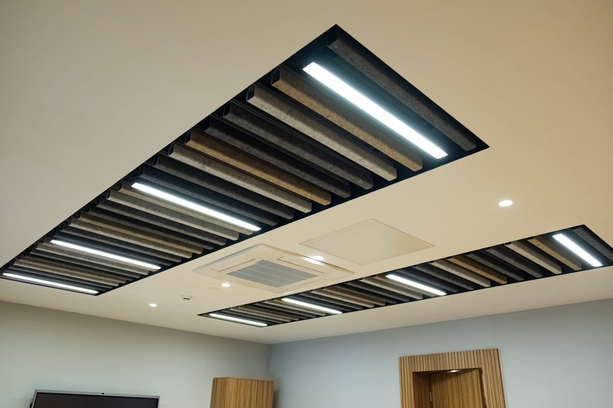 Linear acoustic ceiling baffles with integrated lighting in a commercial interior